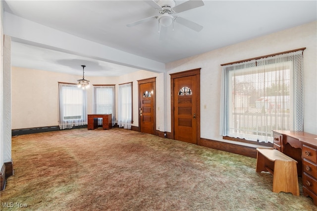 carpeted foyer entrance featuring ceiling fan