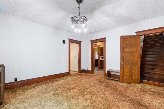 unfurnished bedroom featuring carpet and a chandelier