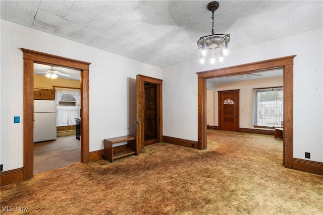 carpeted spare room with ceiling fan