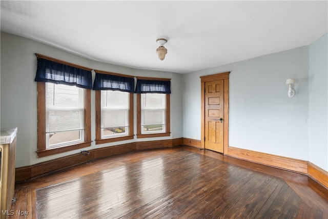 unfurnished room with hardwood / wood-style floors