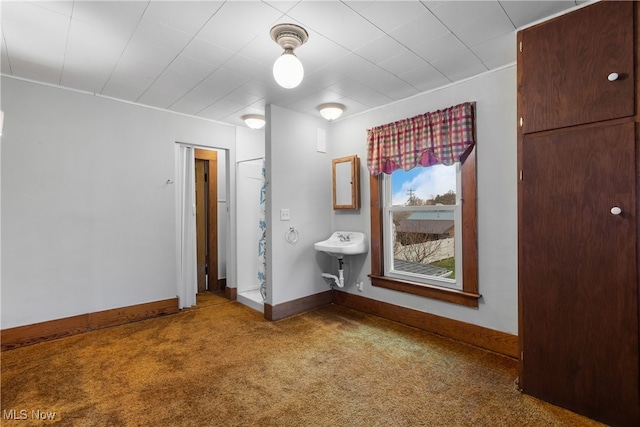 unfurnished bedroom featuring carpet floors and sink