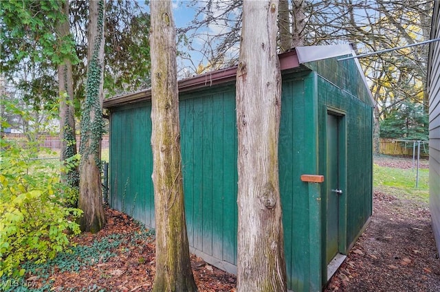 view of shed featuring fence