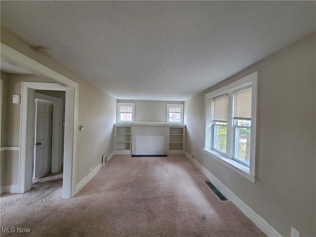 carpeted spare room featuring a textured ceiling