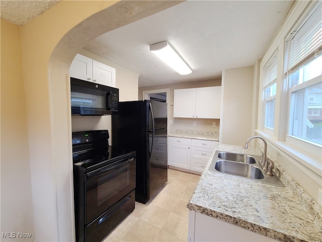 kitchen with white cabinets, a textured ceiling, sink, and black appliances