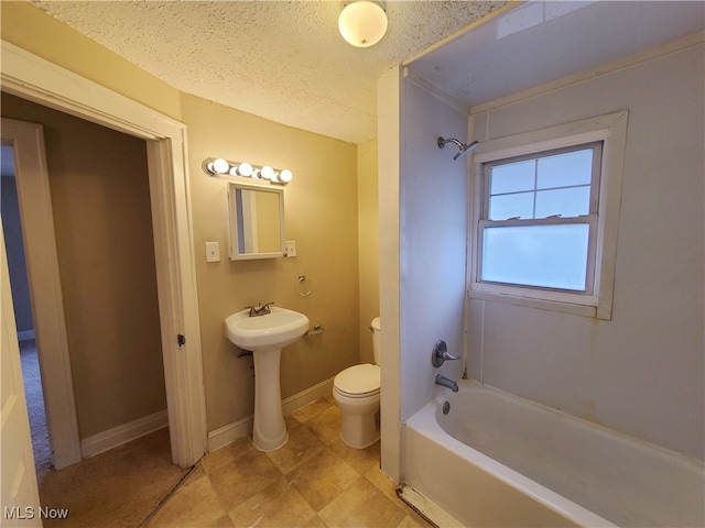 bathroom featuring a textured ceiling, toilet, and sink