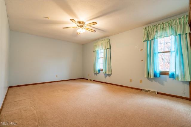 carpeted spare room with ceiling fan