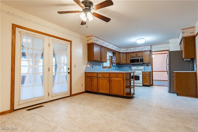 kitchen featuring kitchen peninsula, ceiling fan, sink, and appliances with stainless steel finishes