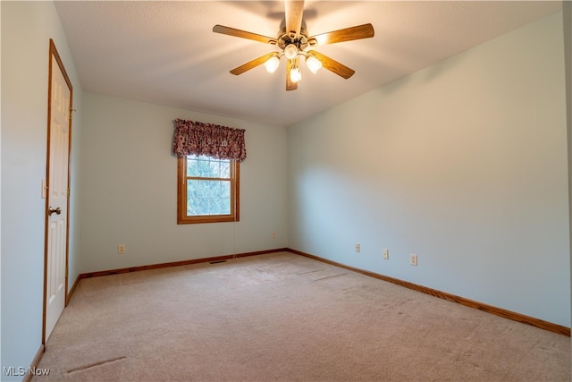 unfurnished room featuring light carpet and ceiling fan