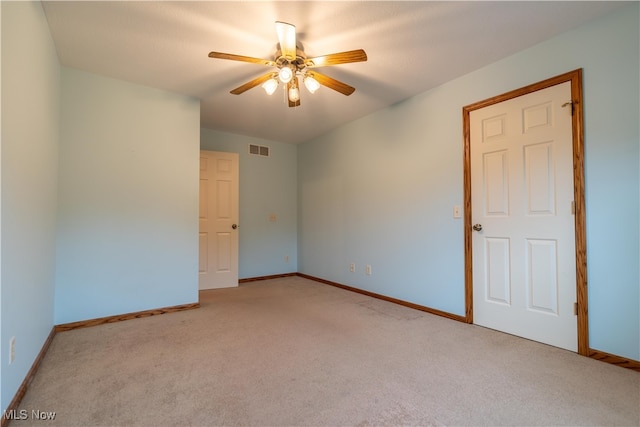 unfurnished room featuring ceiling fan and light colored carpet