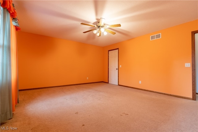 carpeted empty room featuring a textured ceiling and ceiling fan