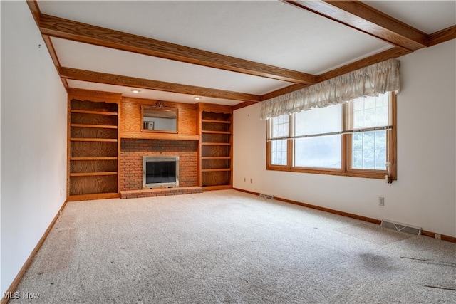 unfurnished living room featuring a fireplace, carpet floors, and beamed ceiling