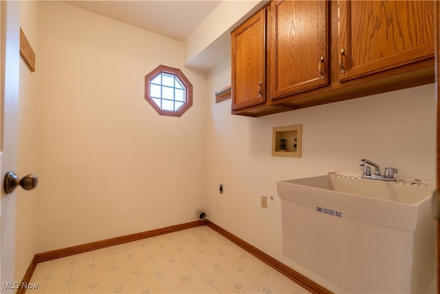 clothes washing area featuring electric dryer hookup, sink, cabinets, and washer hookup