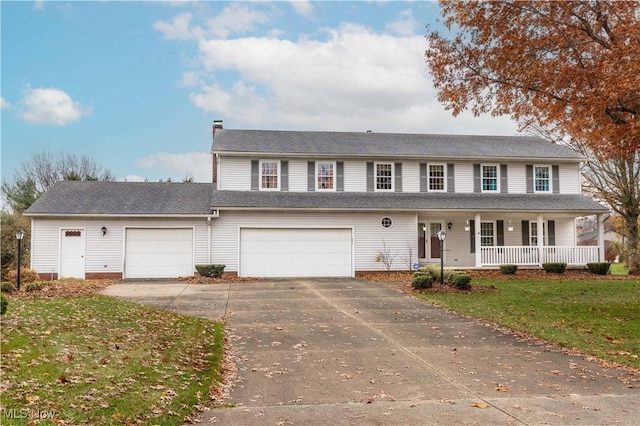 view of front facade featuring a garage, a front yard, and covered porch