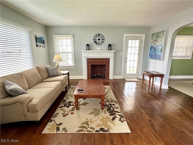 living room featuring dark hardwood / wood-style flooring and a fireplace