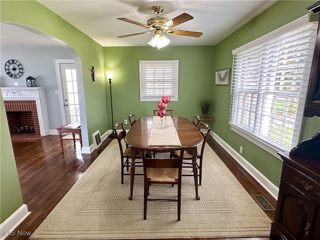 dining space featuring dark hardwood / wood-style floors, a healthy amount of sunlight, and ceiling fan