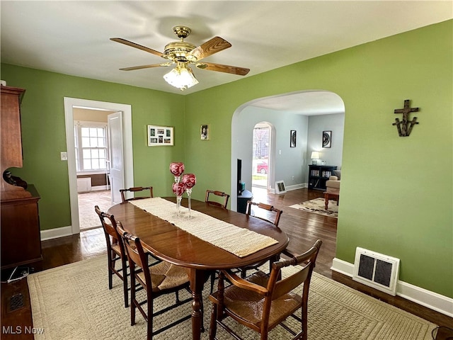 dining space featuring dark hardwood / wood-style floors and ceiling fan