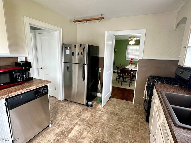 kitchen featuring white cabinetry, sink, ceiling fan, and black appliances