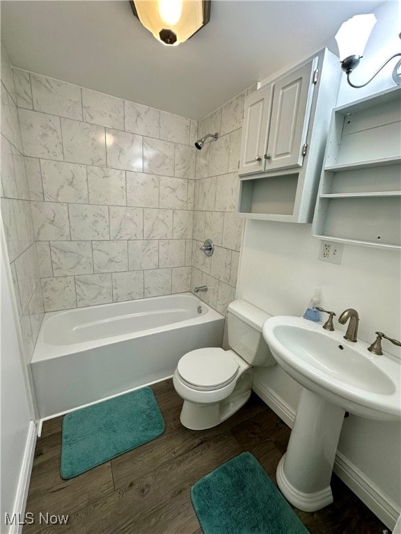 full bathroom with sink, toilet, tiled shower / bath, and hardwood / wood-style flooring