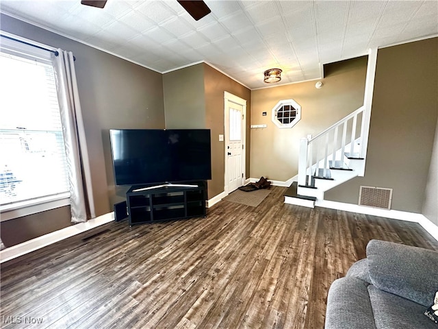 living room with hardwood / wood-style flooring and ornamental molding