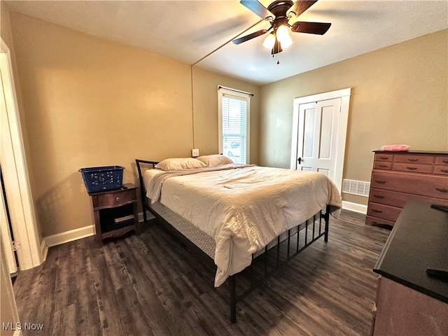 bedroom with ceiling fan and dark hardwood / wood-style flooring