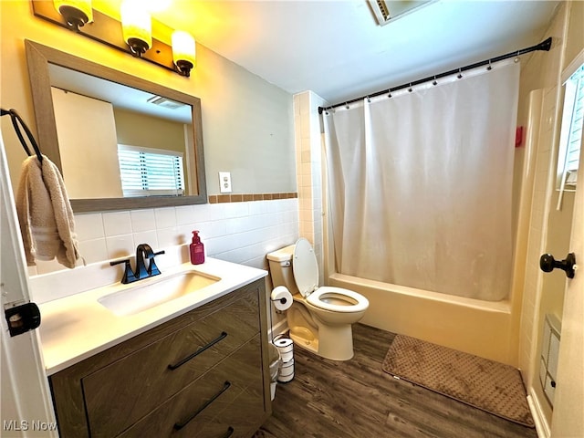 full bathroom with hardwood / wood-style floors, toilet, shower / bathtub combination with curtain, and a healthy amount of sunlight