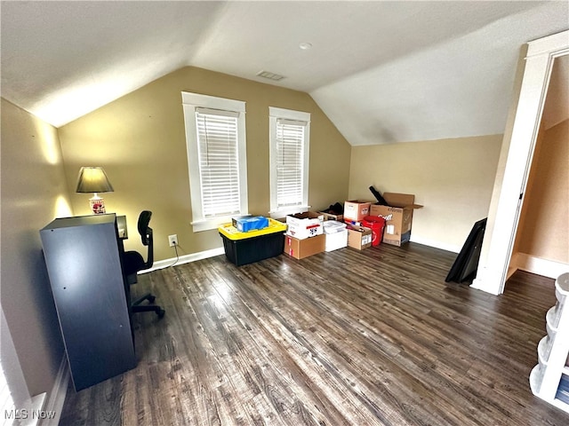 additional living space with dark wood-type flooring and vaulted ceiling