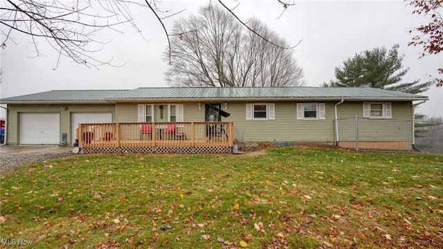 single story home featuring a front yard, a garage, and a wooden deck