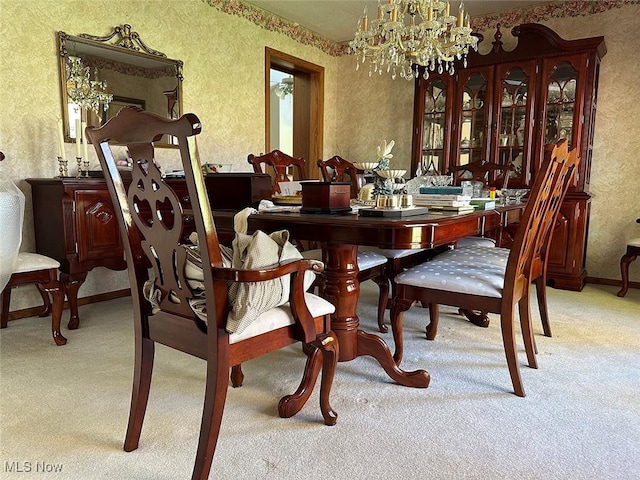 carpeted dining space with an inviting chandelier