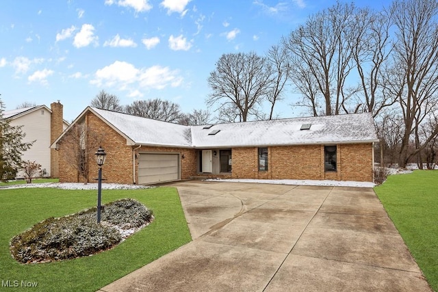 ranch-style home featuring a front yard, an attached garage, brick siding, and driveway