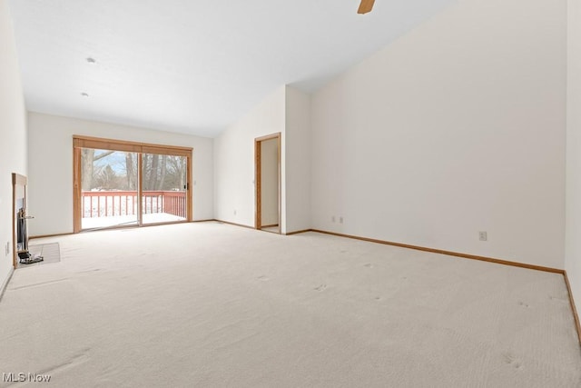 unfurnished living room featuring carpet flooring, ceiling fan, high vaulted ceiling, and baseboards