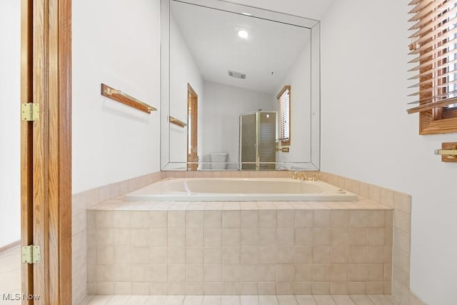 bathroom featuring a shower stall, a bath, and visible vents