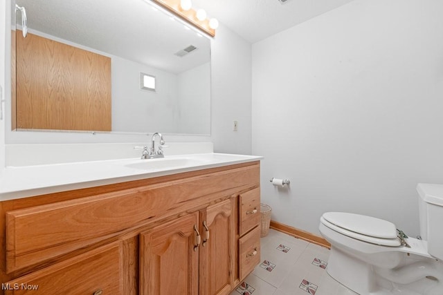 bathroom with visible vents, baseboards, toilet, and vanity