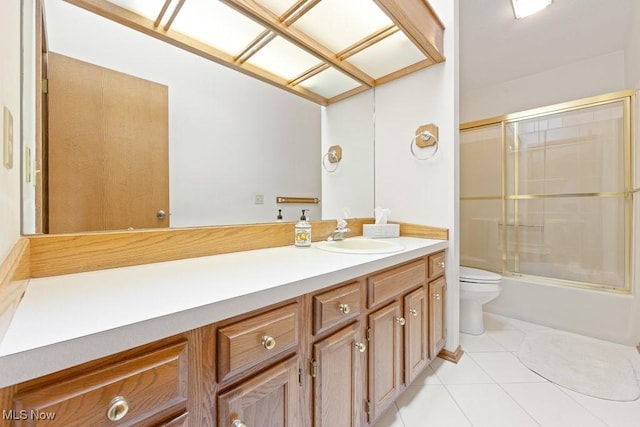 full bathroom with tile patterned floors, enclosed tub / shower combo, toilet, and vanity