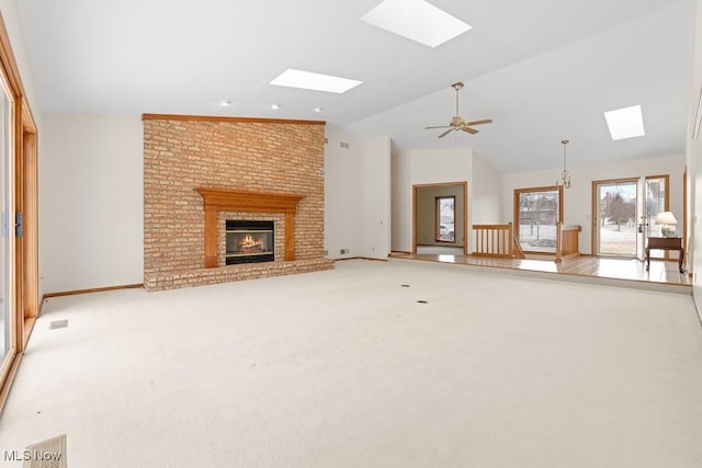 unfurnished living room with visible vents, baseboards, carpet, a fireplace, and lofted ceiling