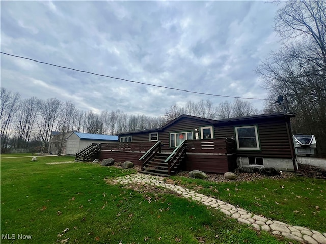 log home featuring a wooden deck and a front lawn