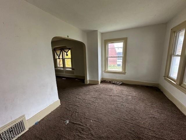 1411 W 21st St, Lorain, OH 44052 - unfurnished room with arched walkways, healthy amount of natural light, and carpet