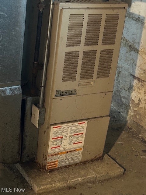 utility room featuring heating unit