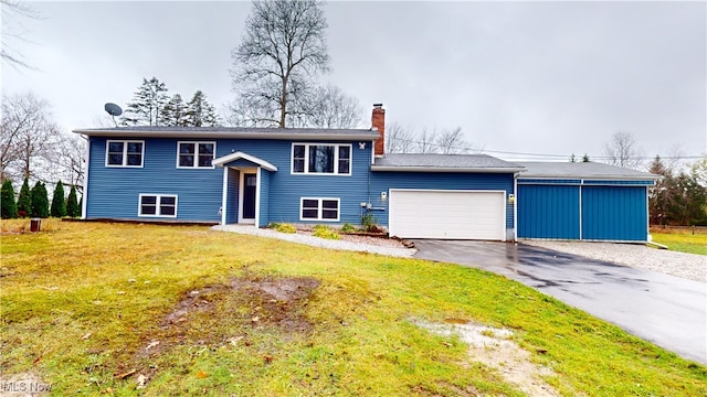 bi-level home with a garage and a front lawn