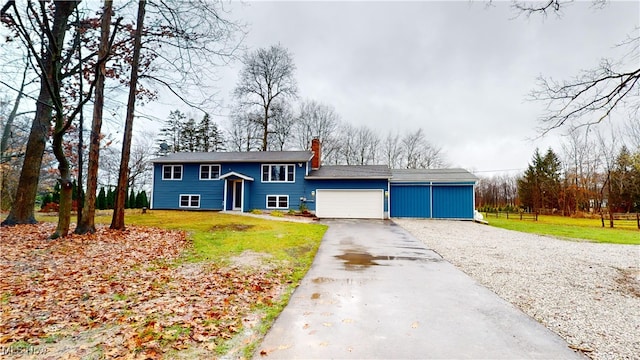 view of front of property with a front yard and a garage