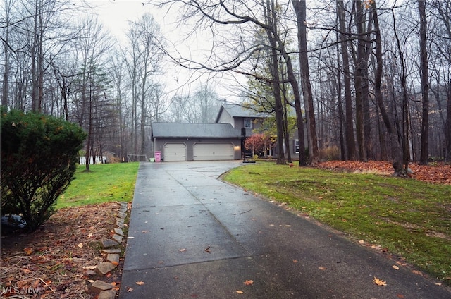 view of front of property featuring a garage and a front yard