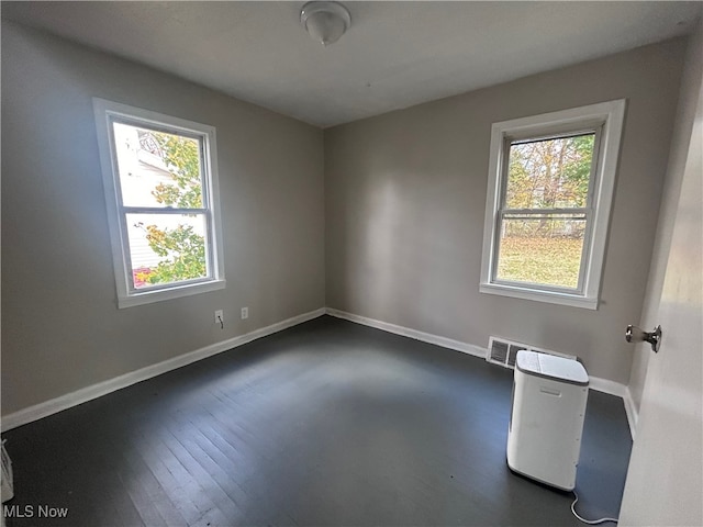 spare room with dark hardwood / wood-style flooring