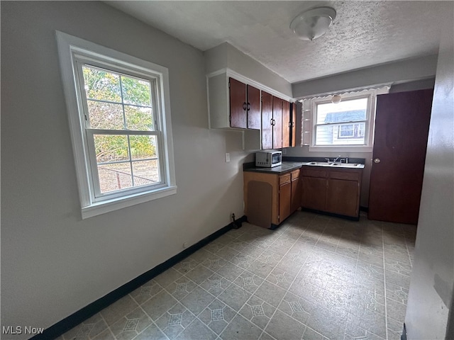 kitchen featuring plenty of natural light and a textured ceiling