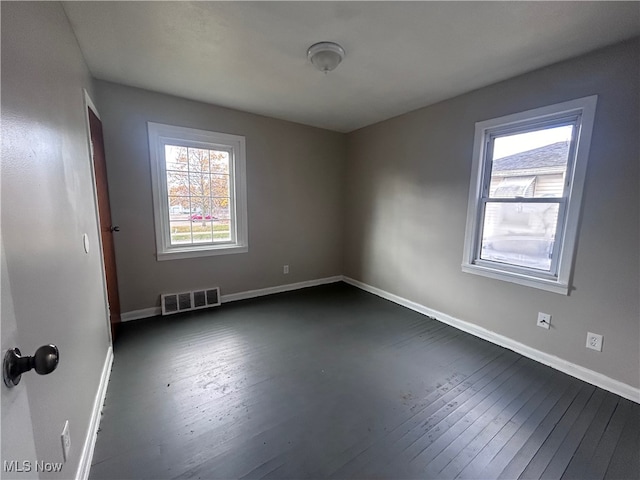 spare room featuring dark wood-type flooring