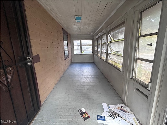 unfurnished sunroom featuring wooden ceiling