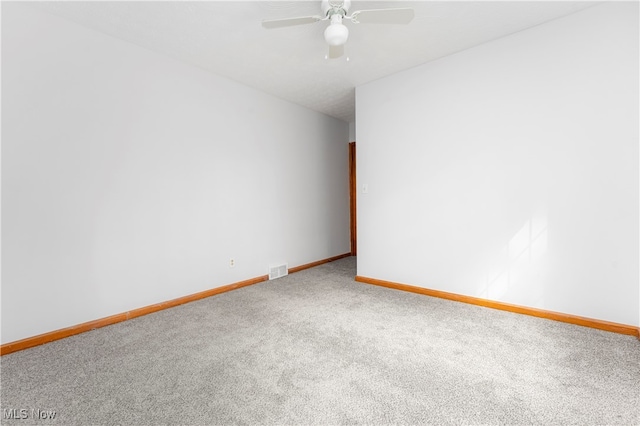 carpeted spare room with ceiling fan