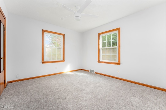 empty room with ceiling fan and carpet floors