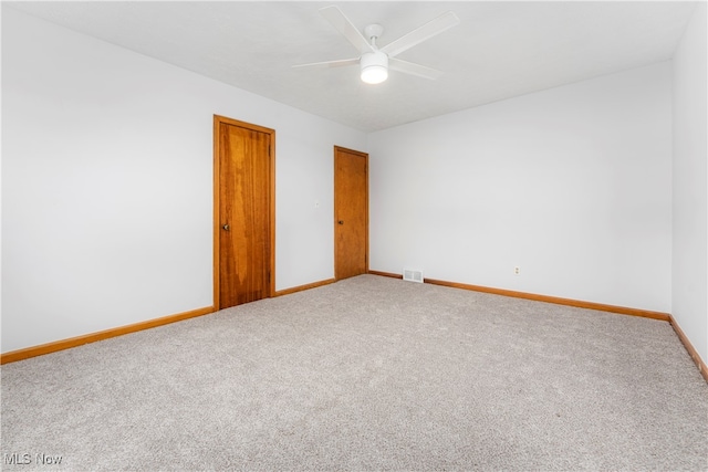 spare room with ceiling fan and carpet floors