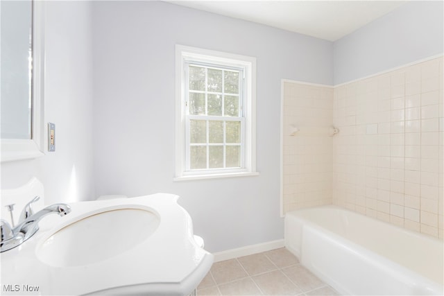 bathroom with tile patterned flooring and tiled shower / bath combo