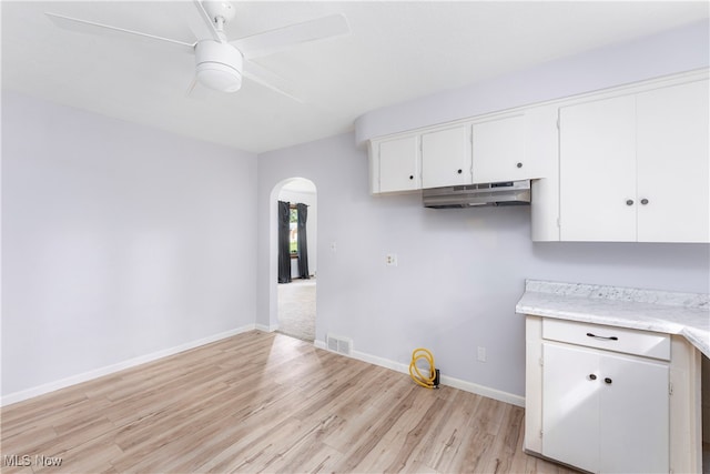 kitchen with white cabinets, light hardwood / wood-style flooring, and ceiling fan