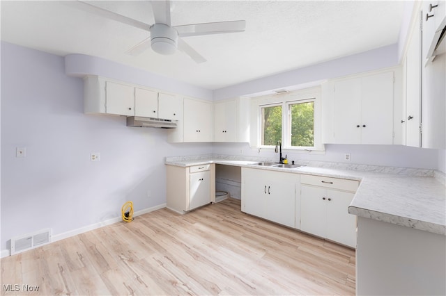 kitchen featuring light wood-type flooring, white cabinetry, ceiling fan, and sink